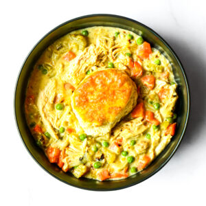 Enjoy Chief's Chicken Pot Pie: creamy chicken and vegetable stew with peas and carrots, topped with a golden-brown biscuit.