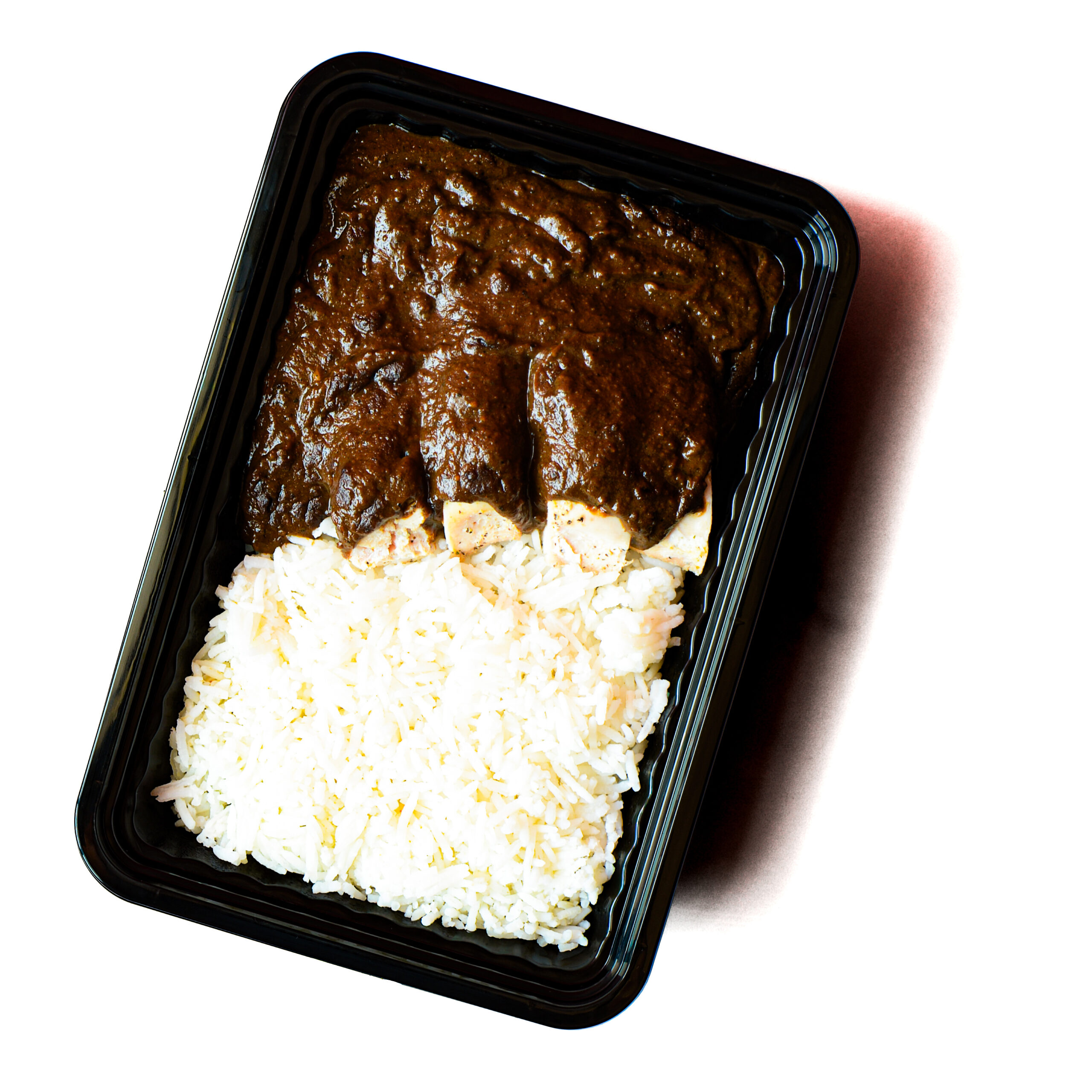 Operation Cajun Fit features a black plastic tray with white rice and tofu topped with rich, dark brown curry sauce.