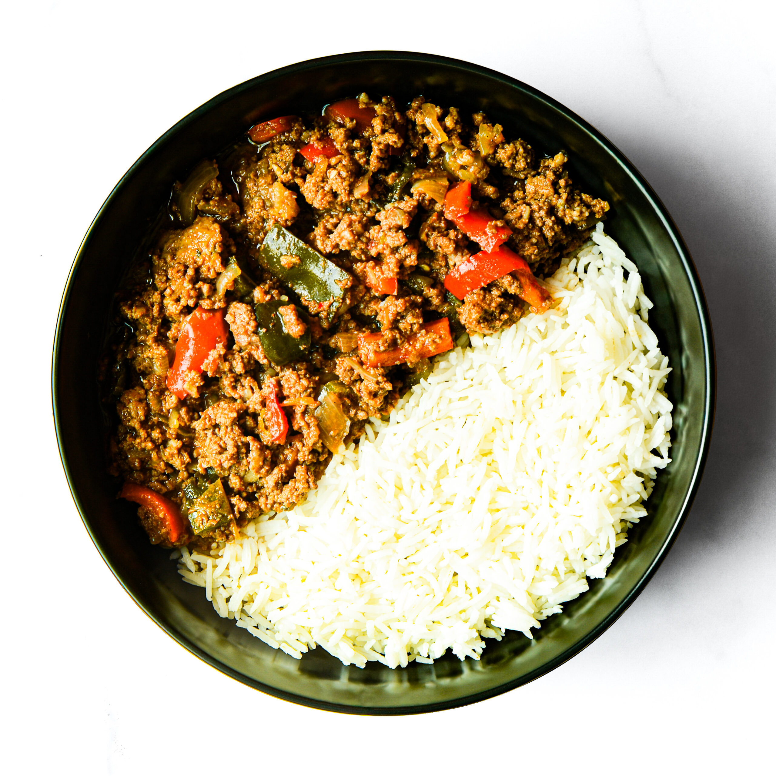 Operation Cajun Fit features a black bowl with white rice on one side and ground beef cooked with bell peppers and vegetables on the other.