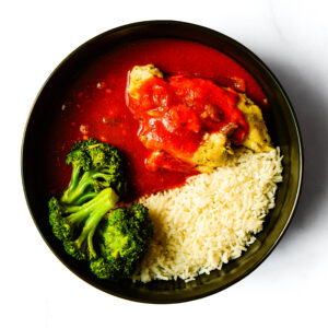 A bowl of Engine 38 Tortellini pasta filled with cheese in a savory sauce.