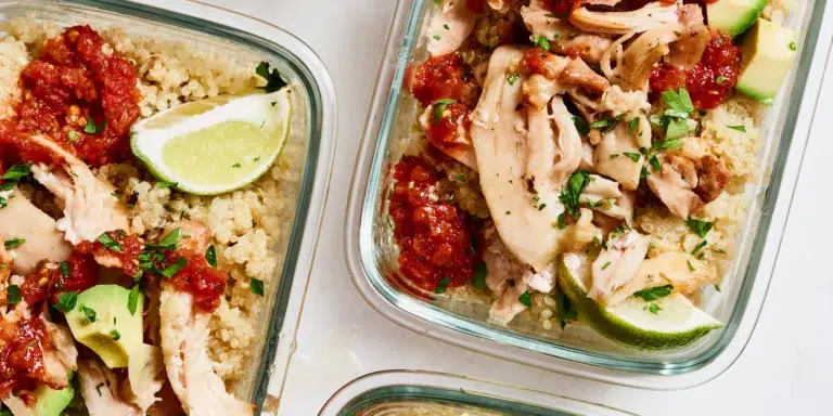 Glass containers filled with shredded chicken, quinoa, salsa, avocado chunks, and lime wedges—perfect for convenient Gluten-Free Meal Delivery meal prep portions.