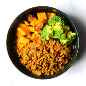 Jack'd-Atouille features ground meat curry, steamed broccoli florets, and roasted sweet potato cubes arranged side by side in a bowl.