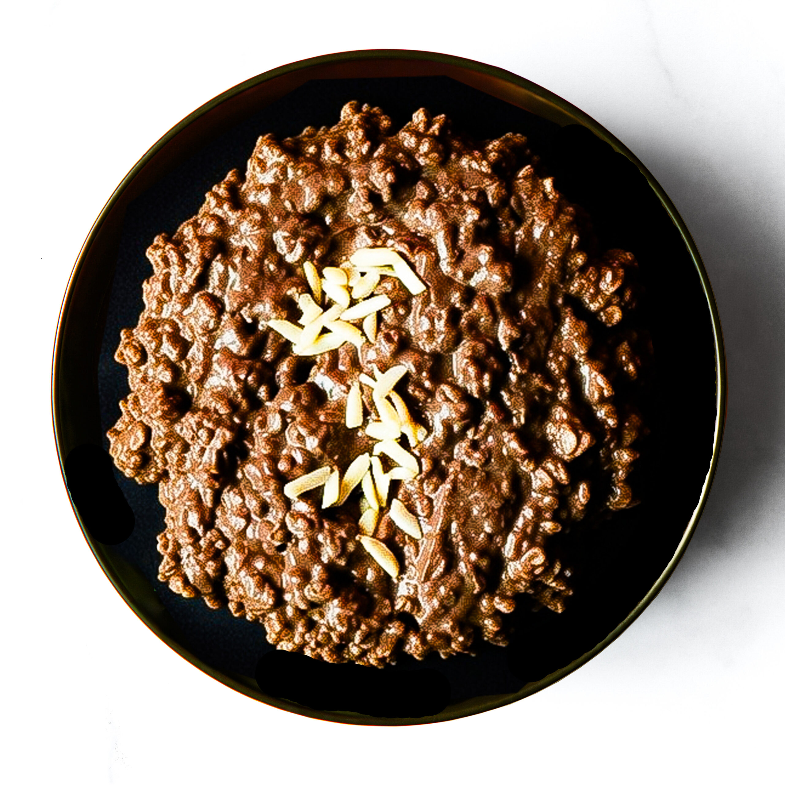 The F*d Up Fajita, served on a black plate and photographed from above, topped with sliced almonds.