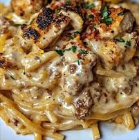 High Noon Linguine: Creamy pasta topped with grilled chicken, fresh herbs, and a lemon wedge.
