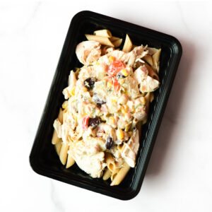 A black container with penne pasta, shredded chicken, and a creamy vegetable sauce, including corn, red peppers, and black olives.