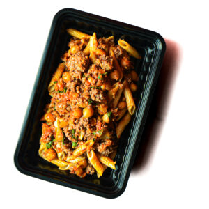 A black plastic container filled with penne pasta, ground meat, chickpeas, and tomato sauce on a white background.