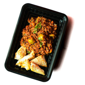 A black plastic container with a serving of cooked fish fillets and a portion of vegetable stew with herbs and green olives.