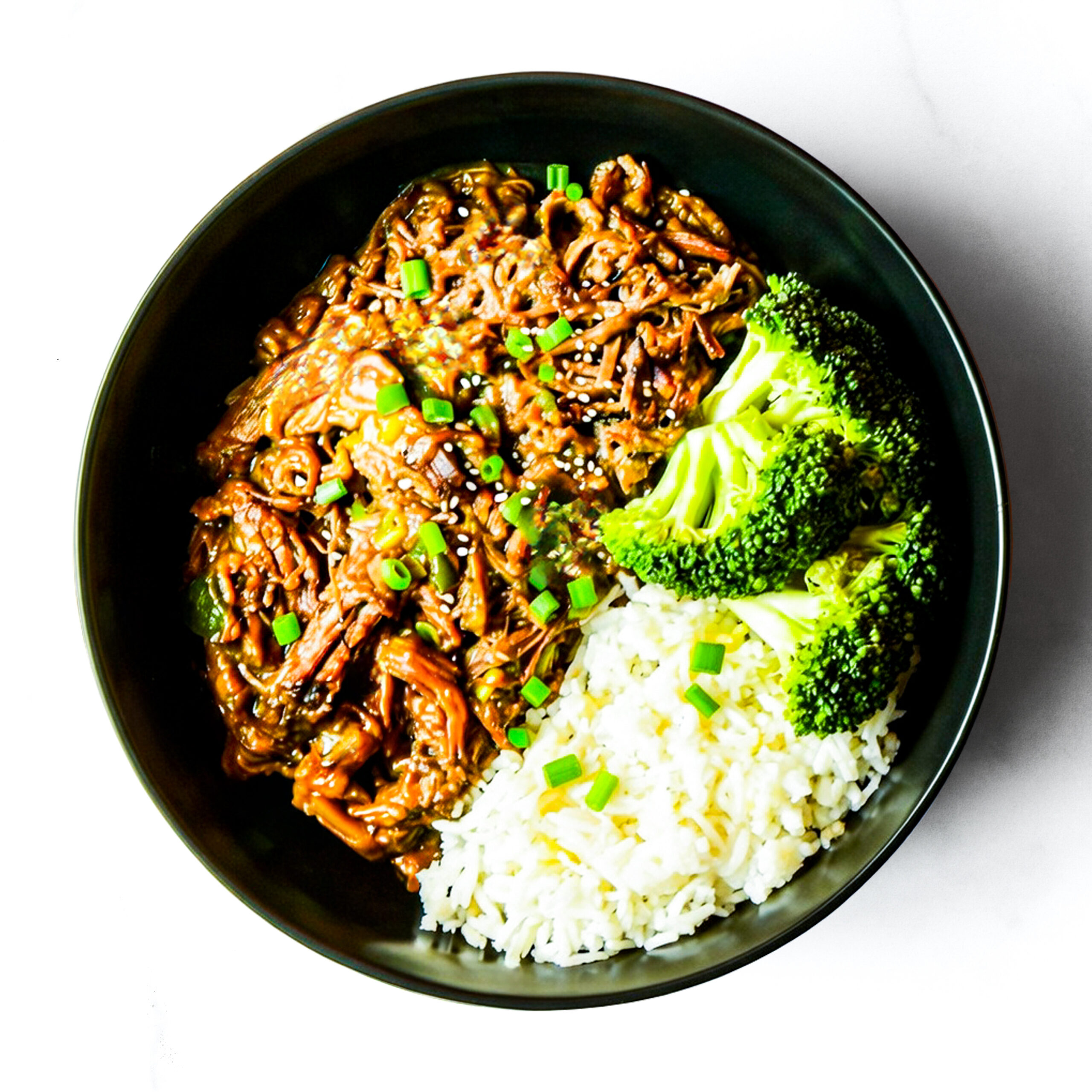 A black bowl filled with shredded meat in sauce, steamed broccoli, and white rice, garnished with chopped green onions and sesame seeds, on a white background.